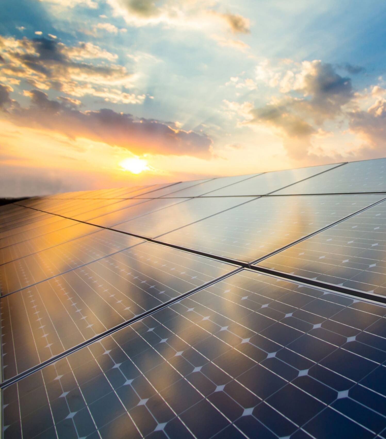 Photovoltaic modules on the background of sunset and cloudy sky